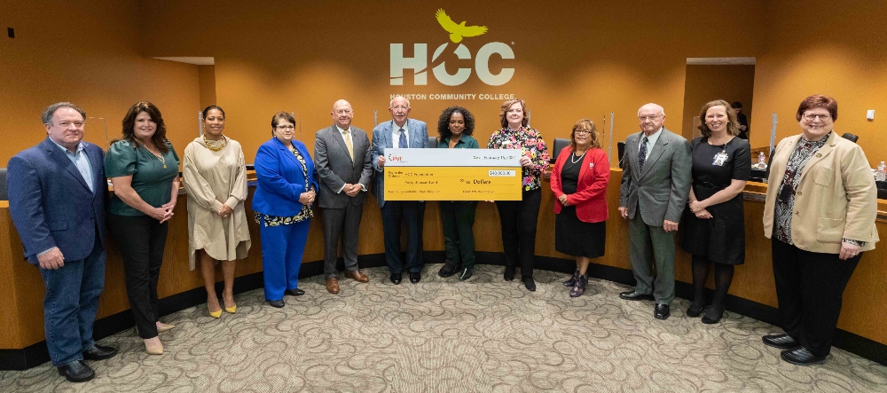 A check presentation at the HCC Board of Trustees meeting