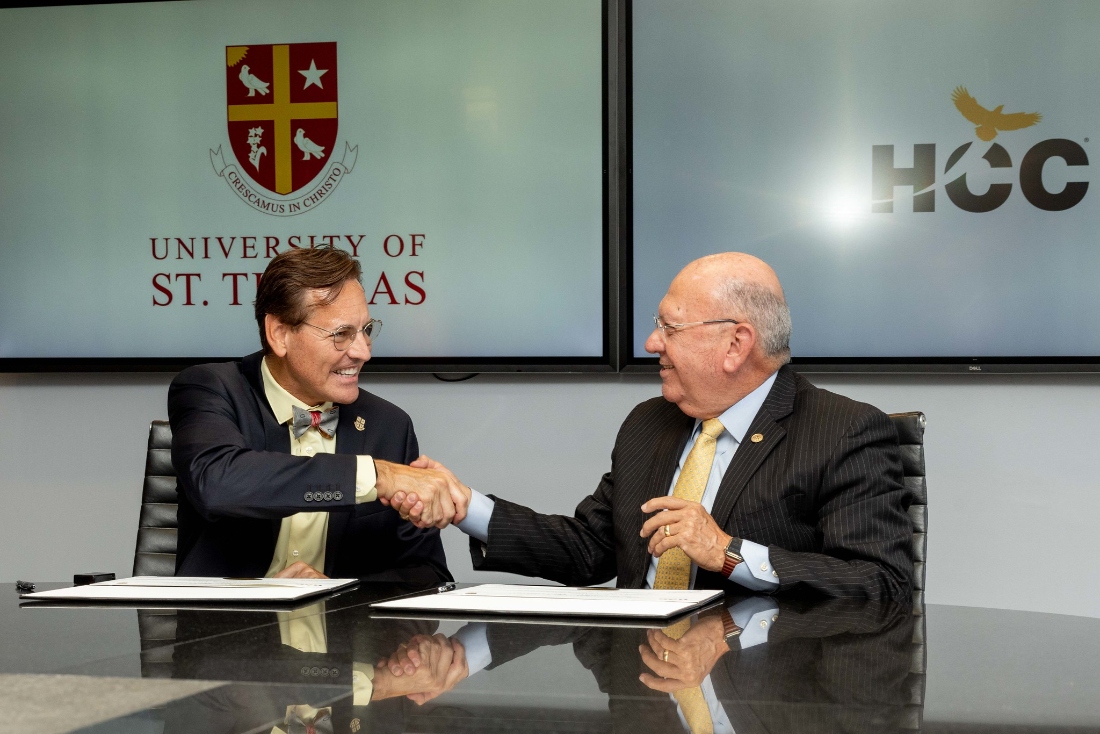 UST President Richard Ludwick (left) and Chancellor Cesar Maldonado shake on the deal.