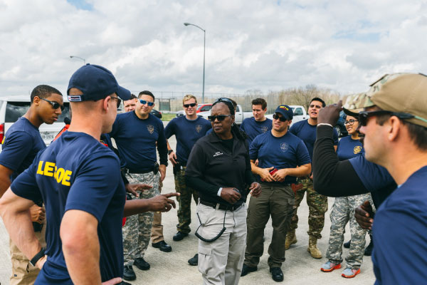 Law enforcement students gathered around an instructor