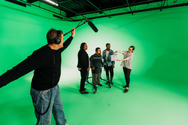 Film Students acting in front of a green screen